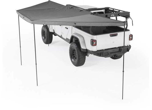 Smittybilt 180° Awning providing shade over a rugged vehicle for ultimate outdoor protection.