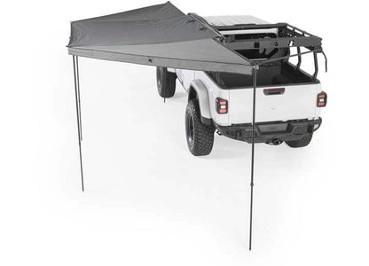 Smittybilt 180° Awning over a vehicle, providing shade and protection for outdoor activities.