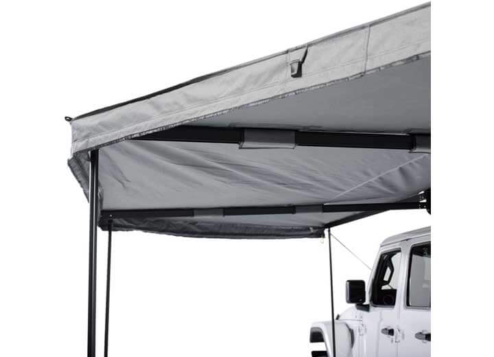 Smittybilt 180° Awning showcasing sturdy support structure and fabric, ideal for overlanding shade.