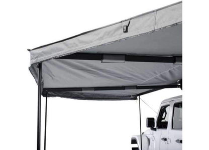 Smittybilt 180° Awning showcasing sturdy support structure and fabric, ideal for overlanding shade.
