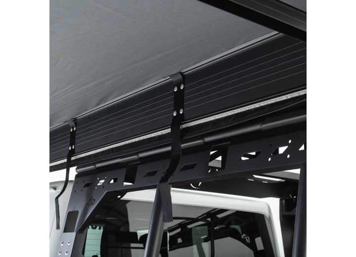 Close-up of Smittybilt 180° Awning mounting brackets on a vehicle roof rack.