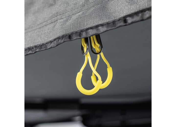 Close-up of Smittybilt 180° Awning's yellow attachment rings for easy setup and secure fastening.